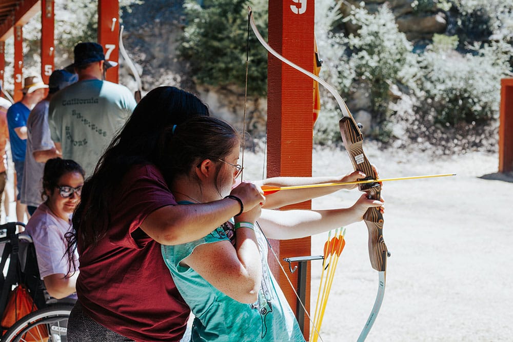 learning archery at summer camp